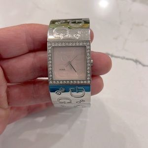 Guess square faced watch with Swarovski crystals outlining the pastel pink face.